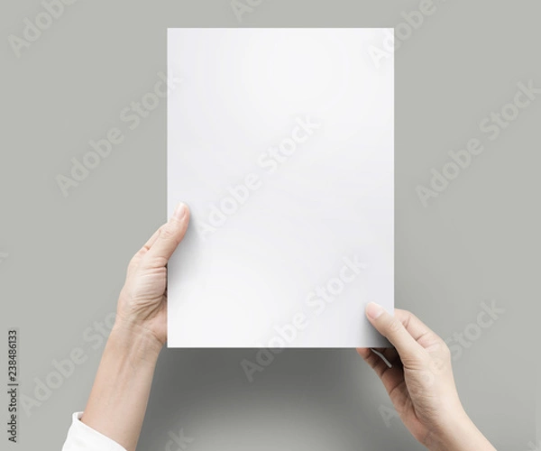 Fototapeta Close up hands holding blank paper for work at desk office top view. clipping path, Isolated.