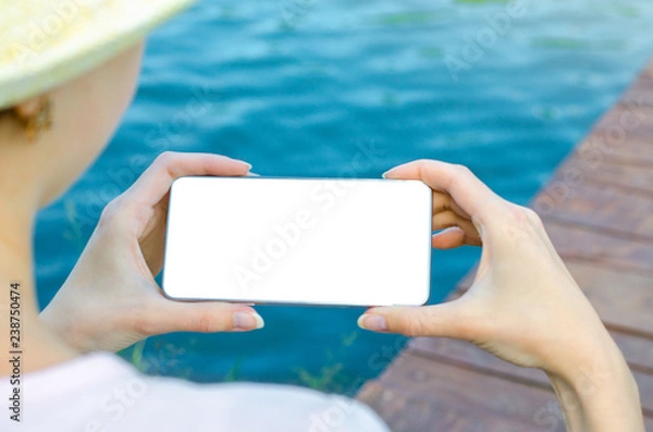 Fototapeta Close Up Business Woman in hat Using Smartphone Mobile Phone Outdoor Black Oled Display Wooden Background Stylish Summer Dressed hipster