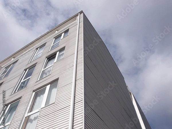 Fototapeta Building facade with metallic cladding. Construction elements of modern architecture 