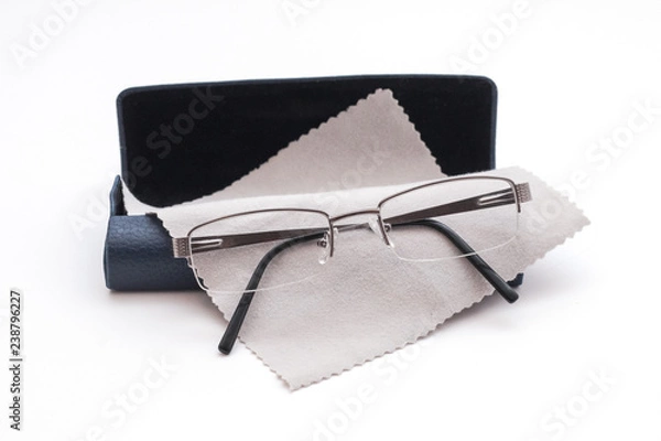 Obraz Glasses and case with glasses cleaning cloth on white background