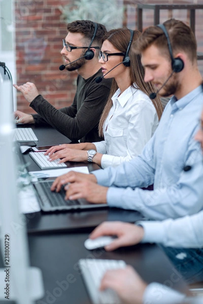 Fototapeta close up.call center operators sitting at the Desk.