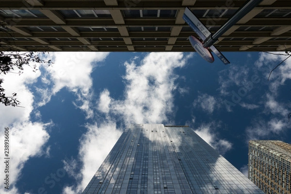 Fototapeta Skyscraper facade with the sky and clouds reflected on the windows. Manhattan, New York city, Usa.