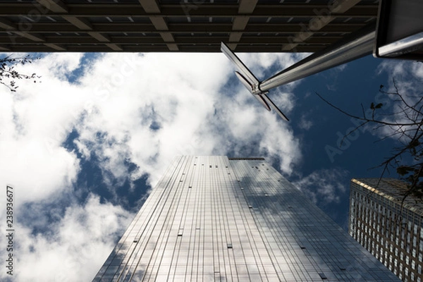 Fototapeta Skyscraper facade with the sky and clouds reflected on the windows. Manhattan, New York city, Usa.