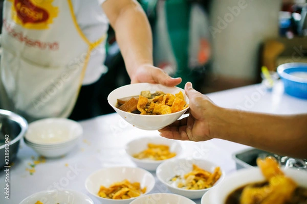 Fototapeta Sharing food with people in poor communities : The concept of feeding