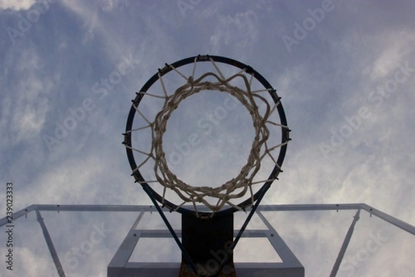 Obraz Look at the blue cloudy sky trough a basketball ring with net and transparent glass board 