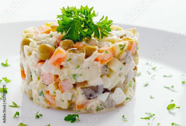 Fototapeta russian olivier salad with chicken decorated with parsley