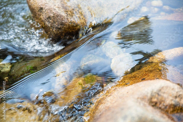 Obraz close up detail of beautiful brilliant and transparent water flowing on rocks and stones in river
