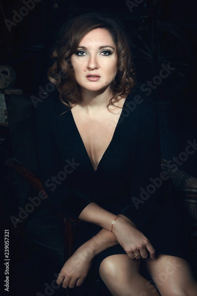 Fototapeta Beautiful model is posing in a dark studio