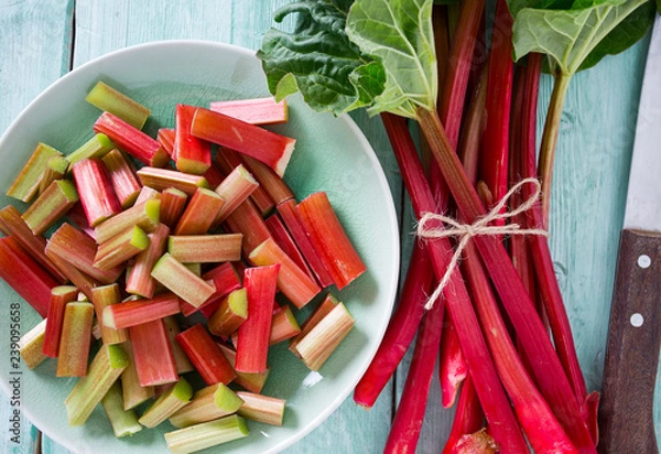 Obraz pieces of rhubarb on turquoise wooden surface