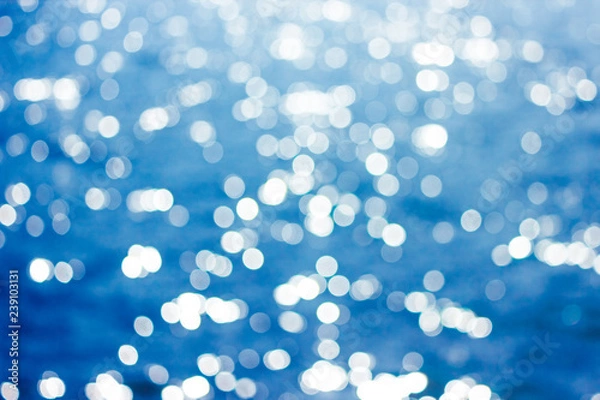 Fototapeta Abstract bokeh sunlight background with summer blue sea.