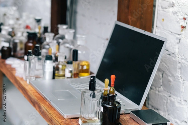 Obraz Close up amber color bottles on the shelf in old perfume laboratory. Flasks and examples of odor in the perfume shop.