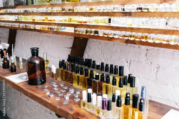 Fototapeta Close up color bottles on the shelf in old perfume laboratory. Flasks and examples of odor in the perfume laboratory and shop