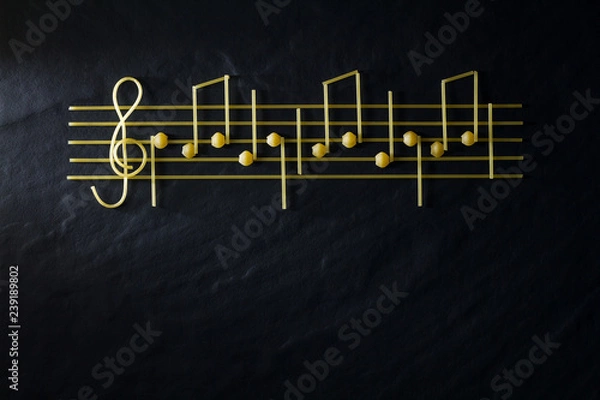 Fototapeta Musical Christmas sheet music paste isolated on a black textural background.