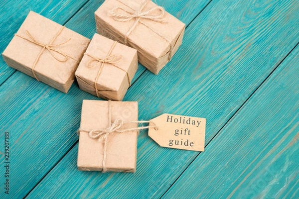 Obraz Gift boxes and tag with text "Holiday gift guide"