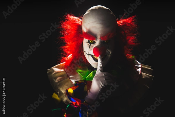 Fototapeta Scary clown on a dark background