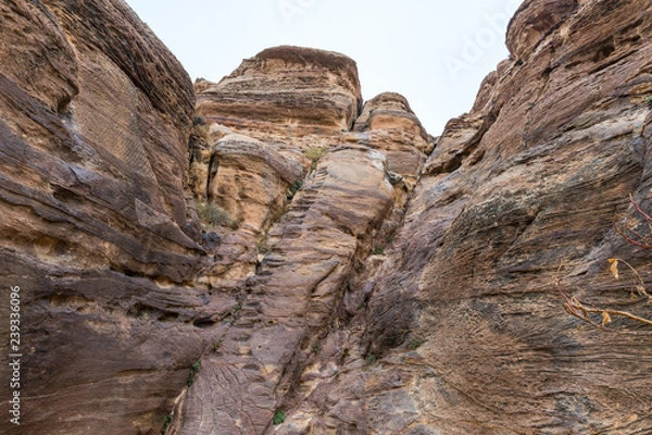 Fototapeta Al-Siq - canyon leading  through red-rock walls to Petra - the capital of the Nabatean kingdom in Wadi Musa city in Jordan