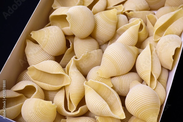Fototapeta Pasta in the form of shells close-up. Culinary Background