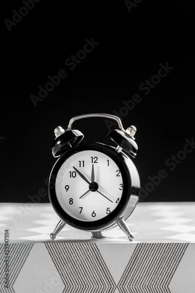 Fototapeta Vintage background with retro alarm clock on table