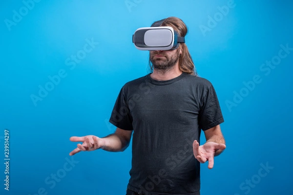 Obraz Male potrait wearing VR device looking confused. Virtual device simulator