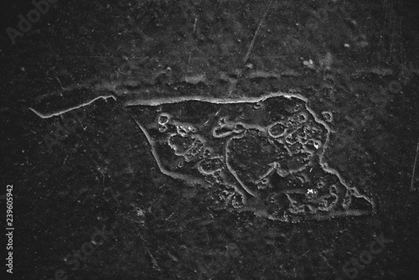 Fototapeta Black-white vintage art background. Texture of decorative grunge stucco. Monochrome book cover. Spotted scratched wall close-up. Backdrop of painted plaster in macro. Artwork plate in grayscale.