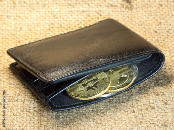 Fototapeta Bitcoin in a purse on rough burlap