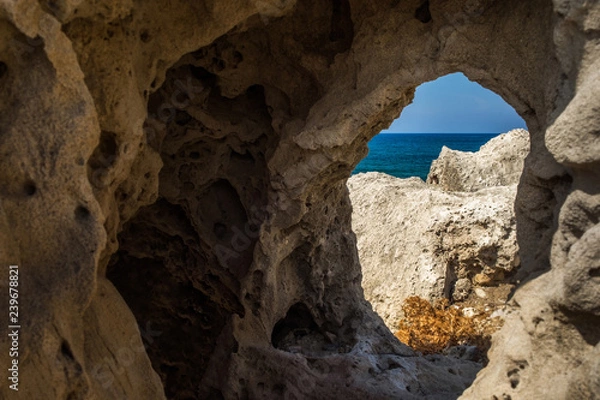 Fototapeta Window in stone with view to the sea