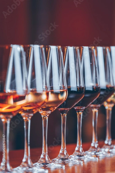 Fototapeta Wine glasses in a row. Buffet table celebration of wine tasting. Nightlife, celebration and entertainment concept