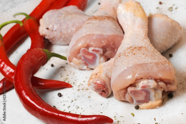 Fototapeta raw chicken with red peppers and spices 