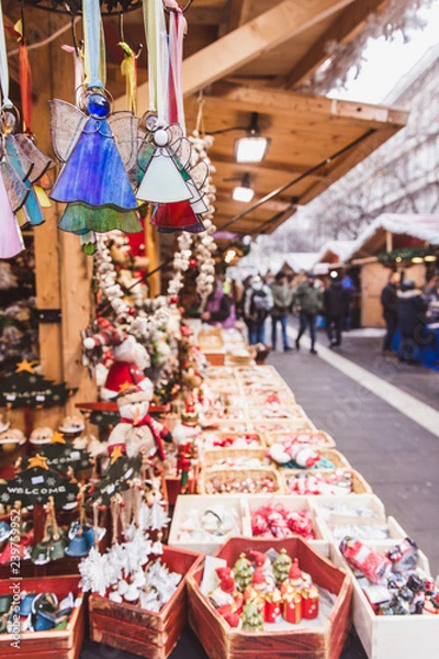 Fototapeta Kiosk with Christmas decorations made in Hungary in the beautiful Christmas Market at St. Stephen's Square in front of the St. Stephen's Basilica in Budapest