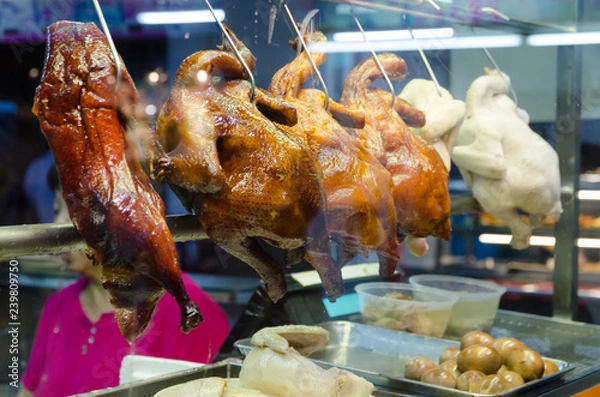 Obraz A row of roasted hainanese ducks in Asian street food market
