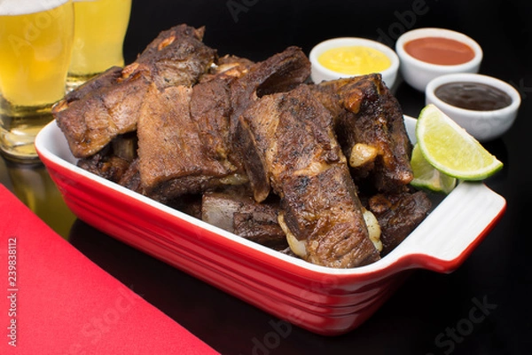 Obraz Fried pork rib in a black pub table