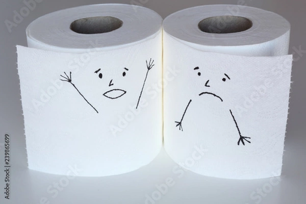 Fototapeta Two white toilet paper rolls sketched with a shouting and a melancholic face, close to each others, representing the panic and the sadness feelings