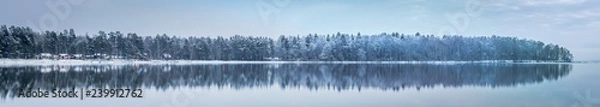 Obraz great panorama of winter forest with some small red houses reflected in a lake