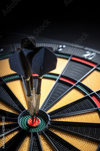 Fototapeta Three darts in bullseye of dartboard