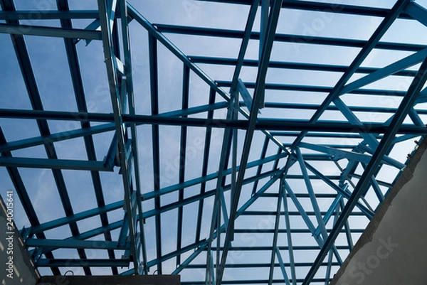 Fototapeta Structure of steel roof frame for building construction.