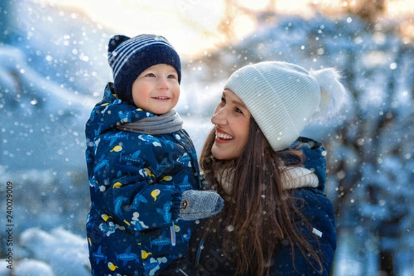 Obraz Woman and child in winter in nature. Portrait of a happy family