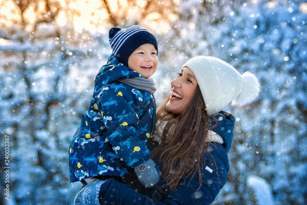 Obraz Woman and child in winter in nature. Portrait of a happy family
