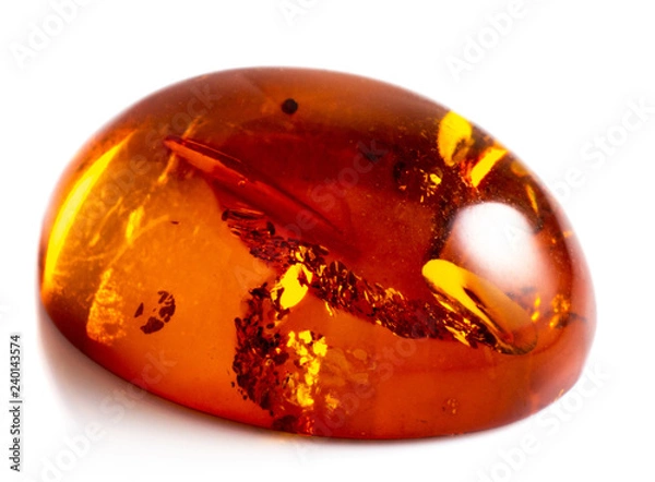 Fototapeta Polished cabochon of artificial amber with inclusions on white background isolated