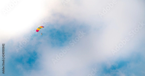 Obraz Parachutist in clouded sky