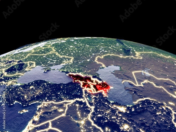 Fototapeta Caucasus region from space on planet Earth at night with bright city lights. Detailed plastic planet surface with real mountains.
