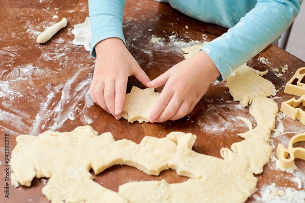 Obraz child makes cookies from dough on the table
