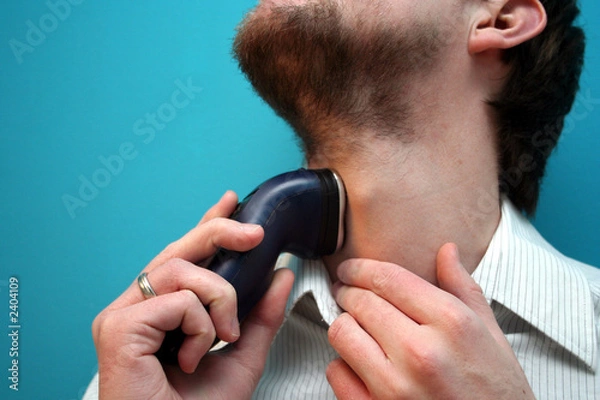 Obraz man using electric shaver