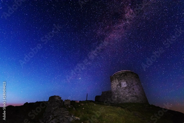 Fototapeta The fiery galaxy Milky way in the night sky with millions of stars over the White Elephant Observatory, which is in the Ukrainian Carpathian Mountains