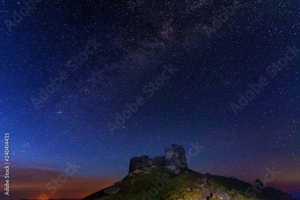 Fototapeta The fiery galaxy Milky way in the night sky with millions of stars over the White Elephant Observatory, which is in the Ukrainian Carpathian Mountains