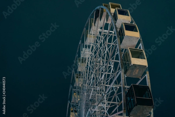 Fototapeta Ferris wheel in dark evening Kyiv on background with deep winter sky