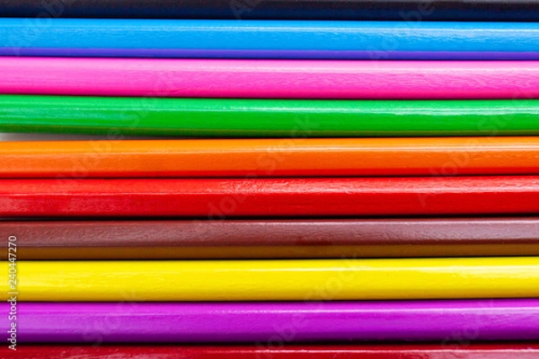 Fototapeta Closeup colorful crayon pencils with rainbow color abstract background textured in horizontal.