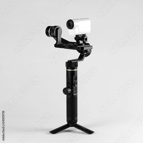 Fototapeta White action camera on three-axis stabilizer. Close up. Isolated on grey background