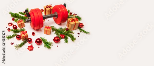 Obraz Christmas or New Year on a white background. Composition with dumbbells, gift, red and gold glass balls, fir tree branches for healthy lifestyle and sport