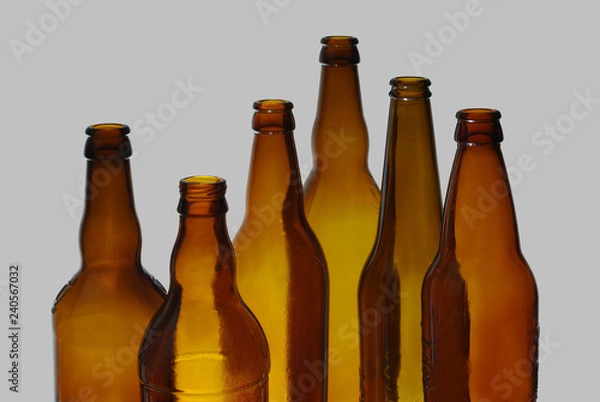 Fototapeta Empty beer bottles. Isolated on a colored background.