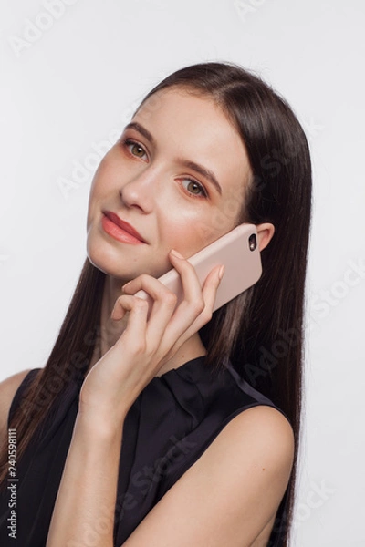 Obraz Portrait of a smiling woman talking by phone
